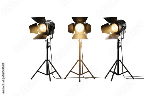 Three studio spotlights on tripods,, lighting equipment isolated on transparent background
