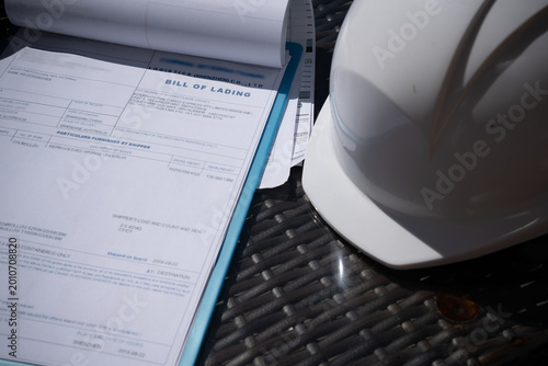 Konstfotografi A tablet with documents or bill of lading a protective helmet close-up