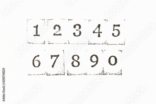 Numbers from 1 to 0 stamped with black ink on clean white background. Minimalist style.