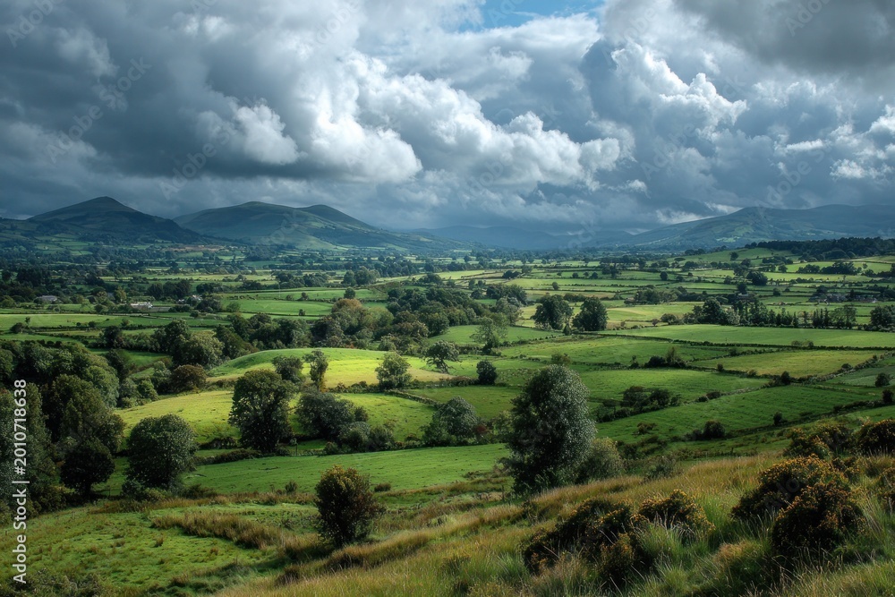 Obraz premium Serene Rolling Hills and Lush Greenery Under Dramatic Sky