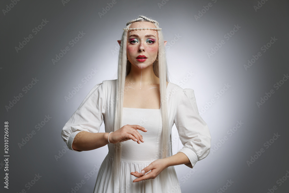 Fototapeta premium Beautiful elf girl on grey gradient background