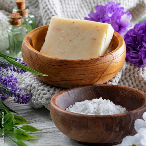 Natural Soap and Sea Salt in Wooden Bowls With Flowers and Green Leaves on a ...