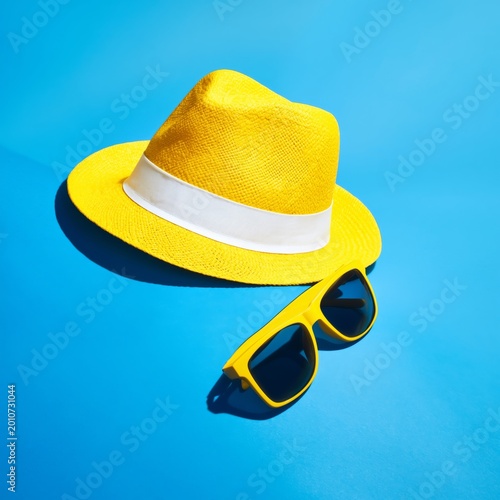 Bright Yellow Hat and Sunglasses by the Pool in Sunny Weather During Summer Time