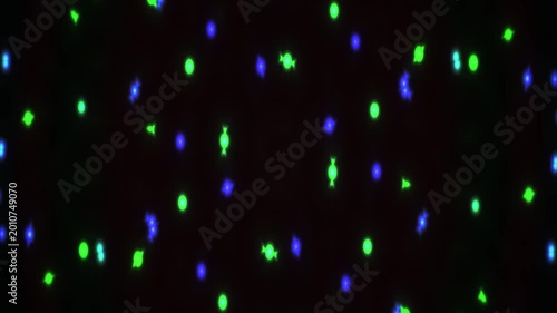 Glowing green and blue dots on black.
