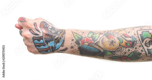 Fotografía Man with tattoos showing fig gesture on white background, closeup
