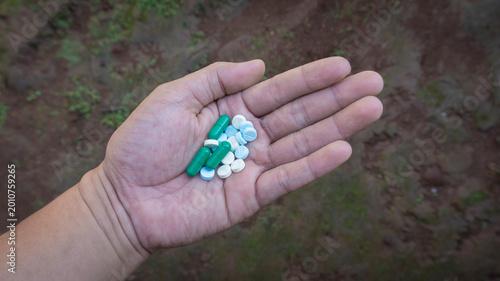 Fotografie Various pills in the palm of the hand, the concept of overdose and addiction