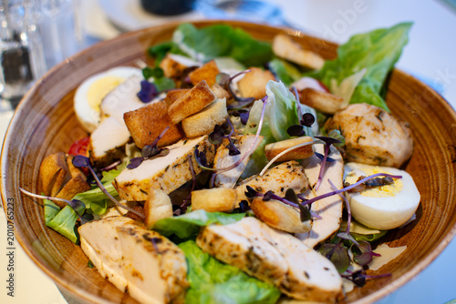 Caesar Salad with crisp romaine lettuce, crunchy croutons, and fresh parmesan cheese, served in a French restaurant