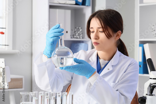 Female scientist with flask...