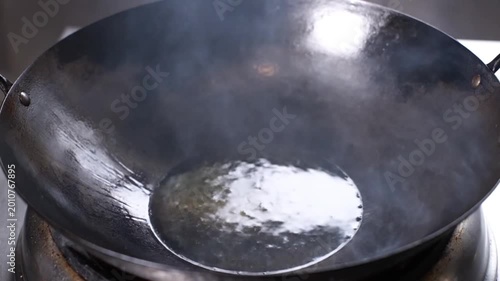 Pouring Cooking Oil into a Hot Smoking Wok