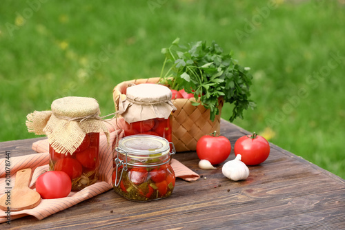 Jars of canned tomatoes wit...