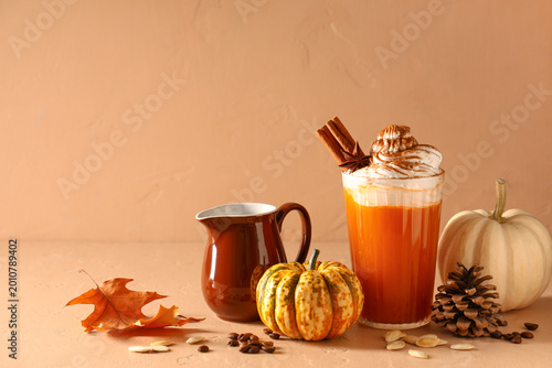 Glass of orange pumpkin lat...