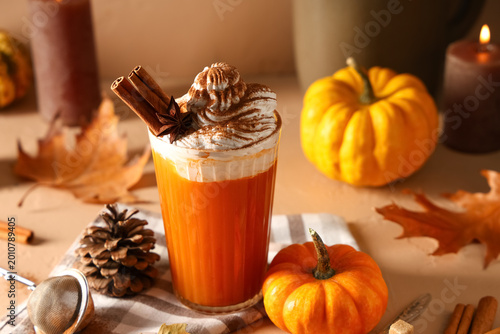 Glass of orange pumpkin lat...