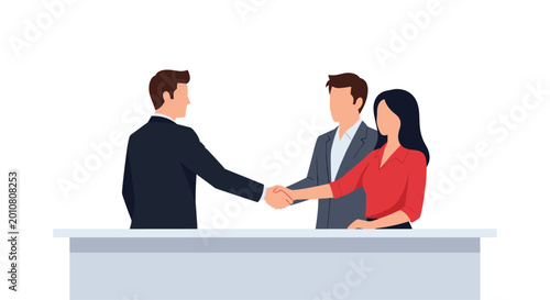 Three professional business colleagues stand behind a sleek desk while two of them shake hands to finalize a successful partnership deal.