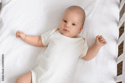 Cute little baby lying in c...