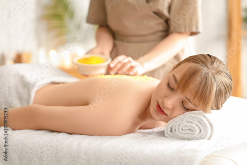 Young woman receiving scrub...