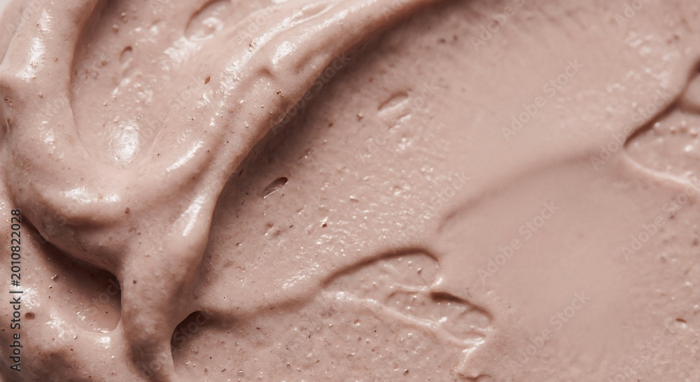 Fototapeta premium Exfoliating pink cosmetic cream texture with natural particles macro background for skincare branding