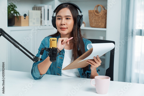 Schilderij op canvas Host channel of young beautiful Asian wearing jeans creative broadcaster talking in online broadcast explaining to promote marketing or consultant in daily life with listener at studio