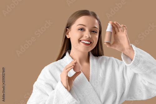 Young woman in bathrobe wit...