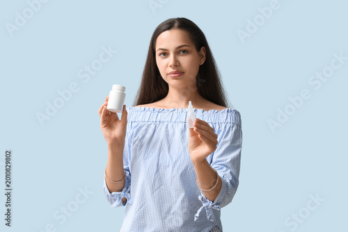 Young woman with nasal drop...