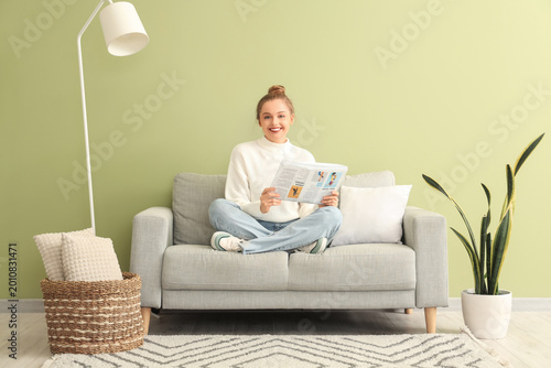 Young woman with newspaper ...