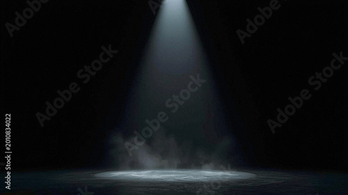 Dramatic spotlight illuminates dark stage with atmospheric smoke and textured concrete floor, creating a mysterious and suspenseful mood. High resolution background for product launches,