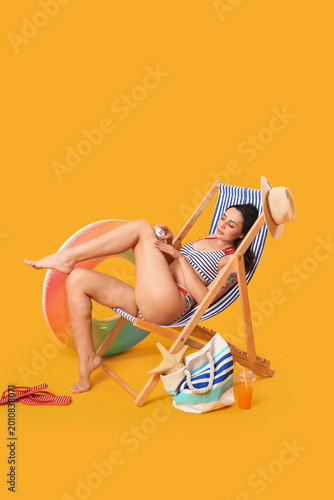 Young woman applying sunscr...
