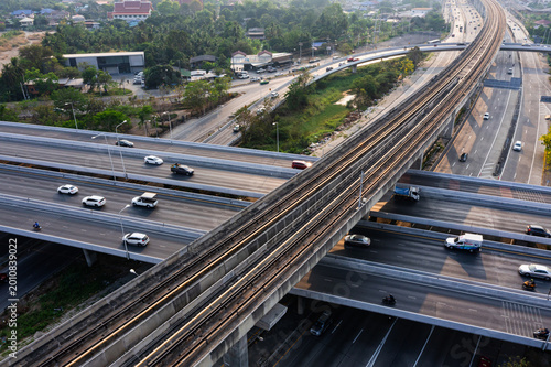 Принти на полотні White cars traverse gray elevated highway with numerous overpasses during peak urban traffic, showcasing modern transportation and intricate road systems within bustling cityscape