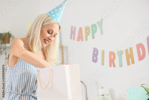Mature woman taking birthda...