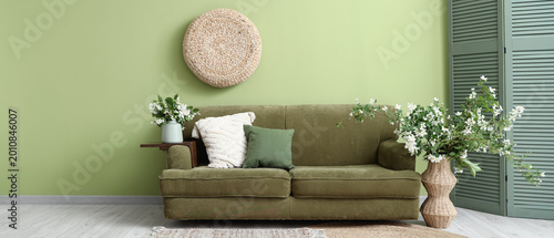 Obraz na plátne Interior of living room with sofa, folding screen and vases with blooming jasmin