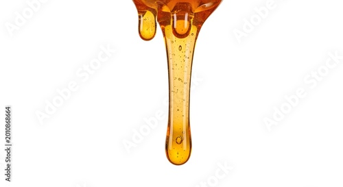 Golden Honey Dripping Down a Transparent Surface Creates a Luxurious Texture and Inviting Viscosity for a Breakfast or Dessert Concept