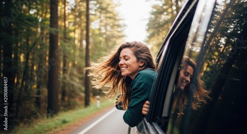 Woman enjoying a car ride in a scenic forest