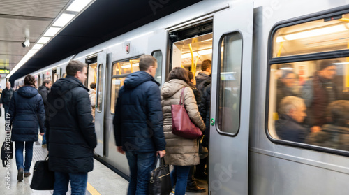 Commuters boarding subway train on busy underground platform during rush hour showing public transportation crowd movement daily urban travel modern metro access workday routine city mobility