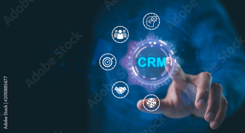 Professional hand interacts with a digital CRM interface featuring icons for AI, teamwork, targeting, and partnerships on a futuristic background. modern business solutions.