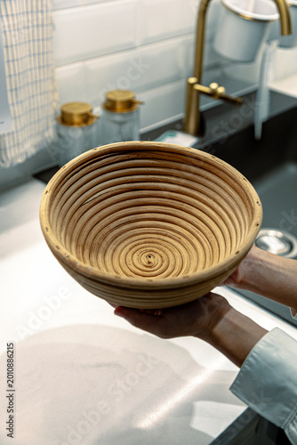 Baker Hands Holding Round Rattan Banneton Basket