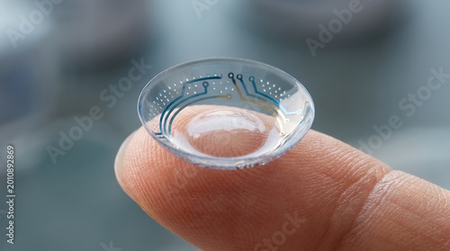 Close up of a technologically advanced contact lens with circuit board patterns resting on a fingertip Futuristic vision correction concept technology eye science innovation