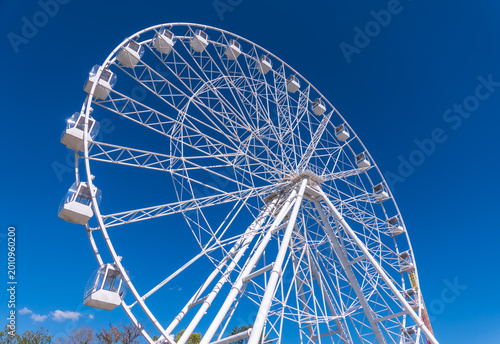 Photos Ferris wheel under blue sky, capturing fun and adventure on a sunny day