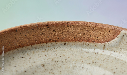 Slanted ceramic dish photography, artistic stoneware plate view, minimalist kitchenware design image, neutral artisan pottery dish, modern speckled clay platter, creative tabletop tableware photograph