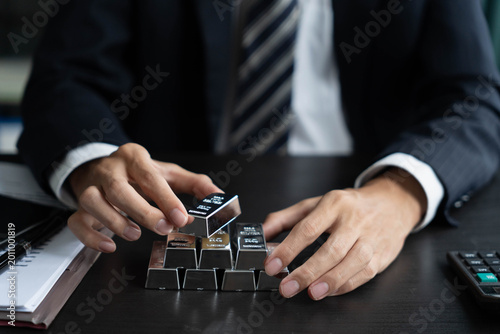 Asian businessman holding silverbar, trading silver concept