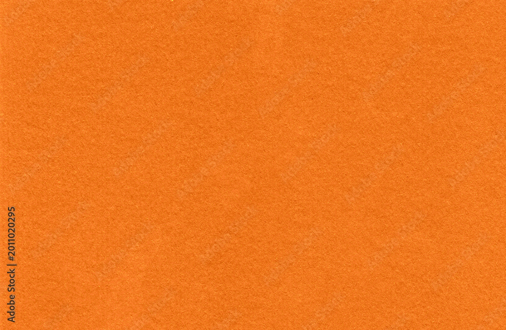 Fototapeta premium Orange textured background with smooth appearance and vibrant color for contemporary graphic projects.