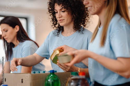 Photos Women volunteers sorting food donations for charity