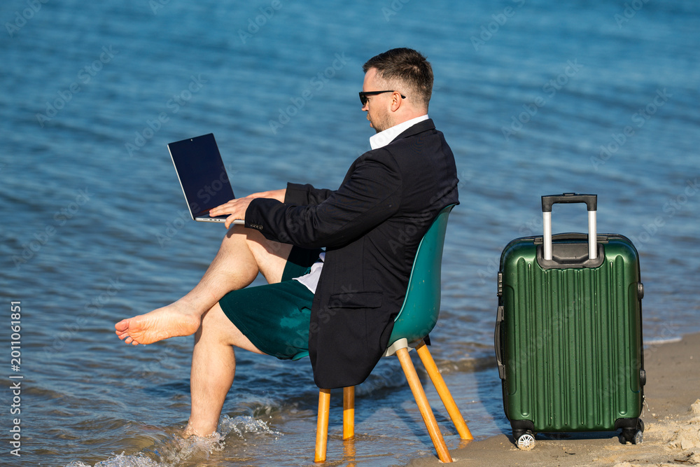 Fototapeta premium Freelancer typing on laptop by sea. Beach freelancer builds online business. Freelancer lifestyle shows travel freedom. Coastal office supports freelancer success.