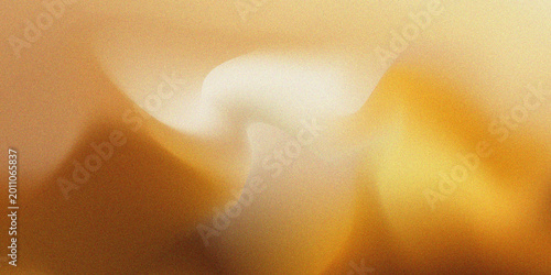 Abstract golden background featuring soft, blurred light gradients and a subtle grainy texture, creating a warm and elegant aesthetic for design projects.