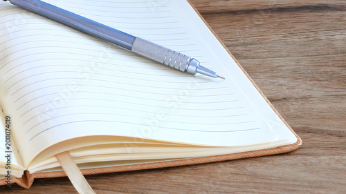 Open Notebook with Mechanical Pencil on Wooden Desk