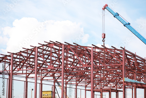 Obraz na płótnie Industrial Construction Site with Steel Frame Building and Crane in Progress