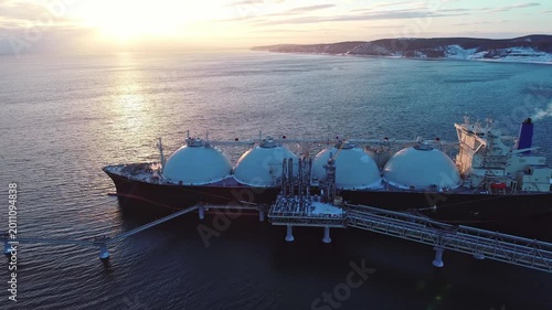 Aerial of Liquified Natural Gas LNG carrier moored to a small gas terminal. Fuel crisis. Sanctions