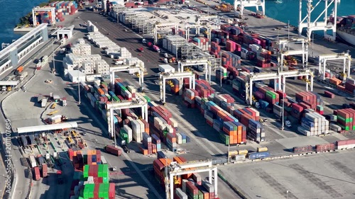 Gantry cranes moving cargo containers in a commercial port, Port Miami.
