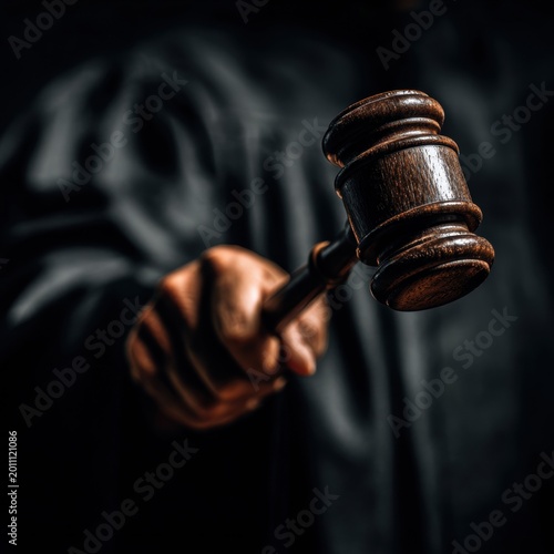 Judgement in Hand: A judge, wielding a gavel with authority, symbolizes the essence of jurisprudence and the administration of justice. Capturing the essence of legal procedure and its gravitas