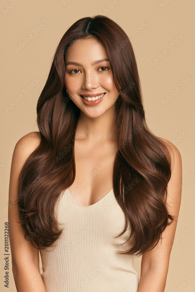 Fototapeta premium gorgeous asian woman with long silky shiny hair on beige background, elegant asian beauty portrait with healthy smooth long hair studio beige backdrop, natural asian model with radiant silky hair