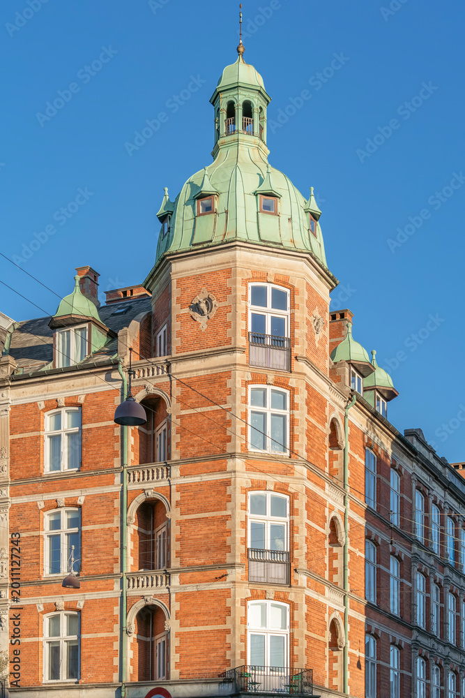 Fototapeta premium Historic Red Brick Building with Green Copper Turret, Copenhagen, Denmark