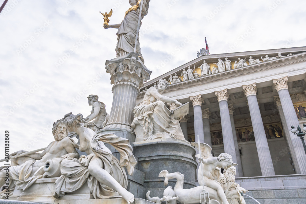 Fototapeta premium Detailed view of marble sculptures at the Pallas Athene Fountain and Austrian Parliament